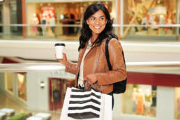 Woman in Mall carrying shopping bags